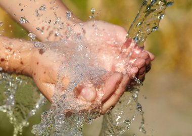 Woman's hands with water splash clipart