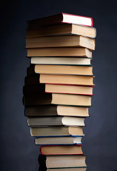 Stos książek na czarnym tle — Zdjęcie stockowe