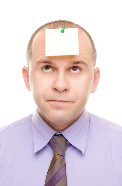Businessman with a note on his head — Stock Photo, Image
