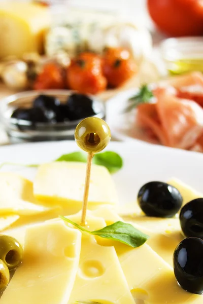 Cured cheese with olives — Stock Photo, Image