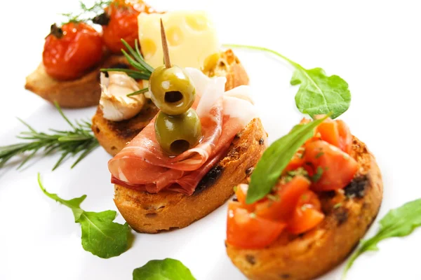 Bruschette with prosciutto and olive — Stock Photo, Image