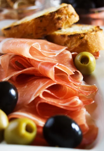 Prosciutto di Parma with olives — Stock Photo, Image
