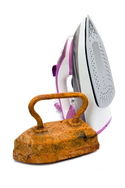 Old rusty pig-iron iron and modern new electric iron — Stock Photo, Image