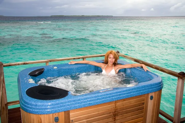 Woman in jacuzzi on background of ocean — Stock Photo, Image