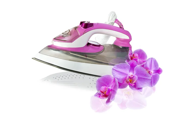 Modern new pink electric iron and orchid flowers — Stock Photo, Image