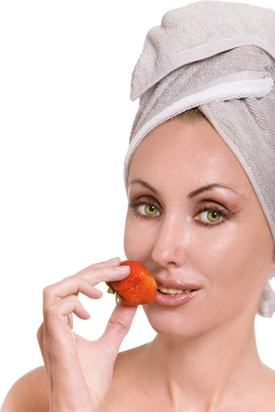 Beautiful young woman in towel with a strawberry — Stock Photo, Image