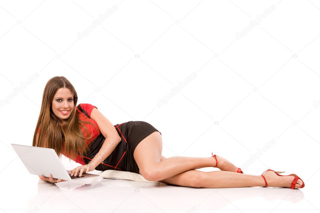 Attractive young woman using laptop on floor