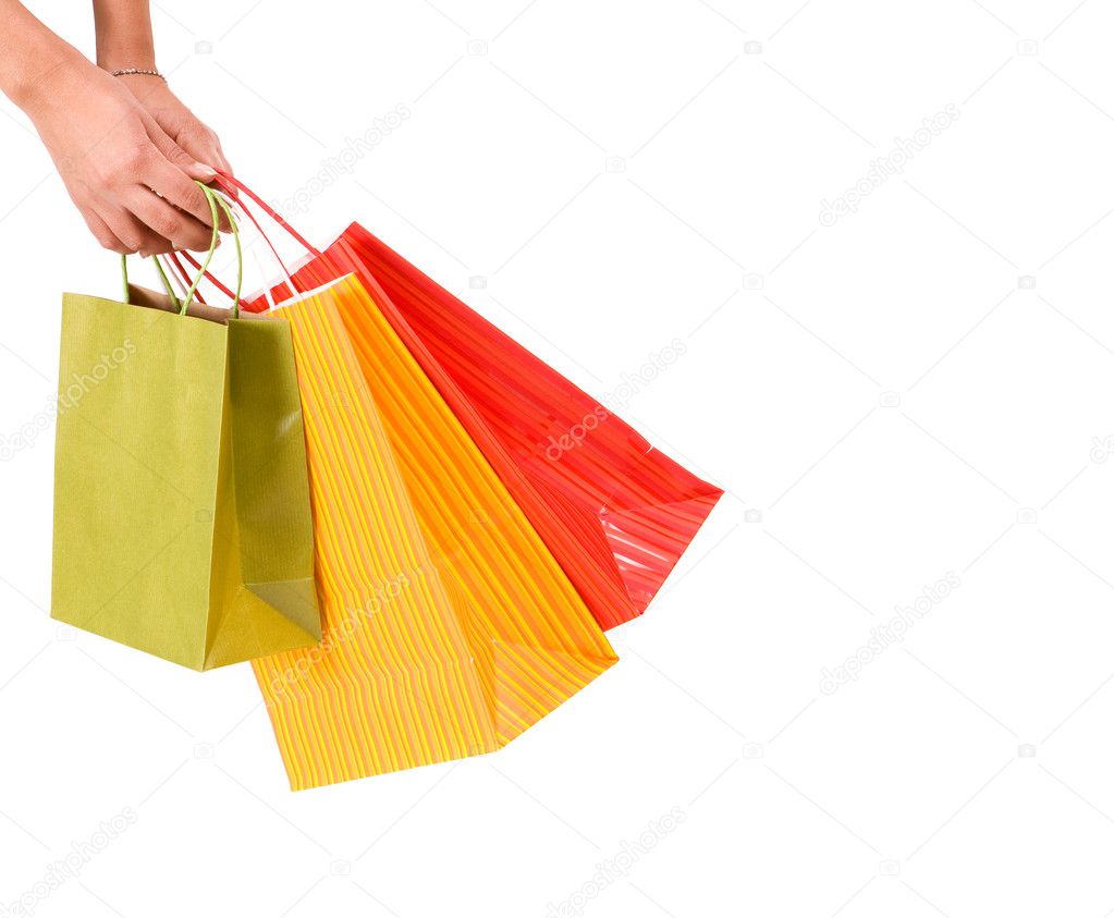 Female hands hold colorful shopping bag
