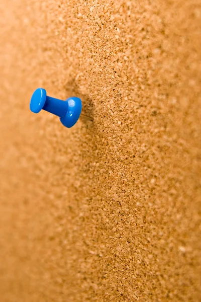 Blue push pins stuck into a cork board. Stock Photo