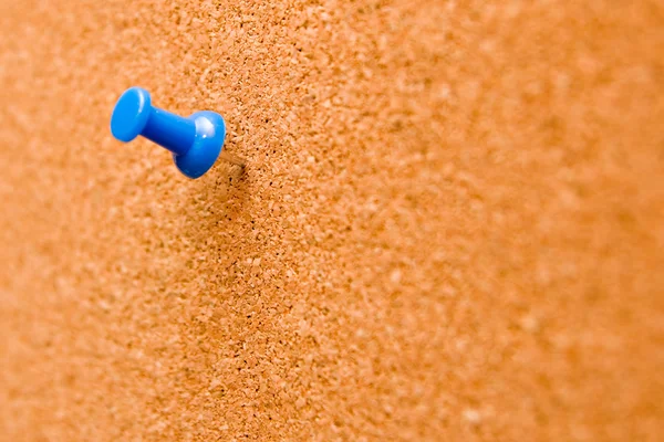 Blue push pins stuck into a cork board. Stock Picture