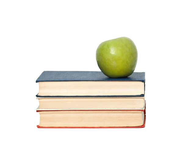 Green apple on pile of books on white background — Stock Photo, Image