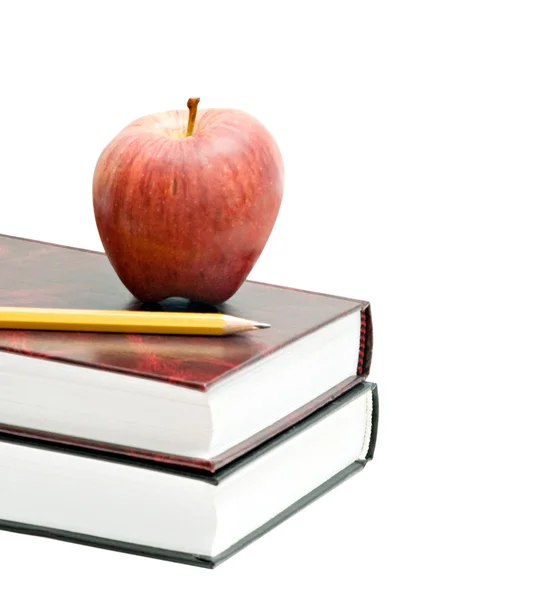 Red apple and pencil on pile of books — Stock Photo, Image