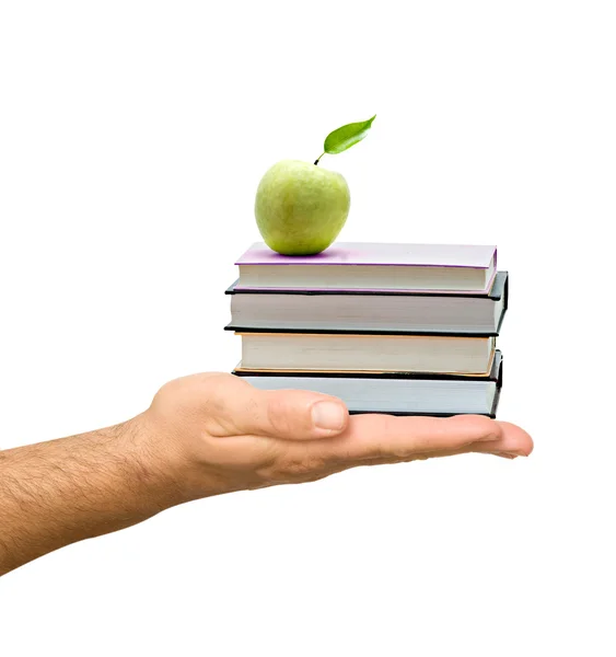 Books with apple in hand as a gift of education — Stock Photo, Image