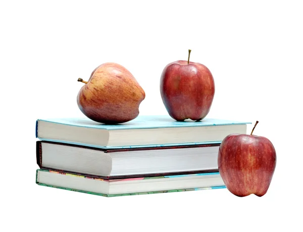Böcker och tre röda äpplen — Stockfoto