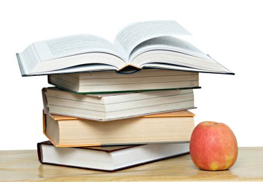 Red apple and open book on desk clipart