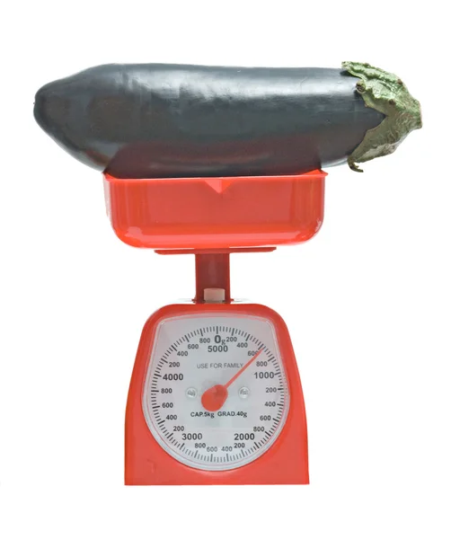 Kitchen scale weighting eggplant — Stock Photo, Image