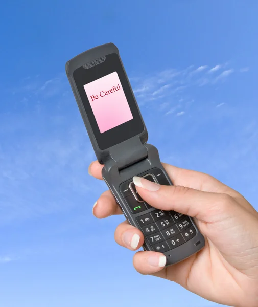 Mobile phone with "Be careful" label on its screen — Stock Photo, Image