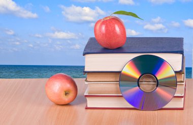 Apple, dvd, and books as a symbol of transition from old to new clipart