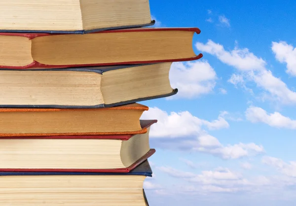 Pile of books on sky background — Stock Photo, Image