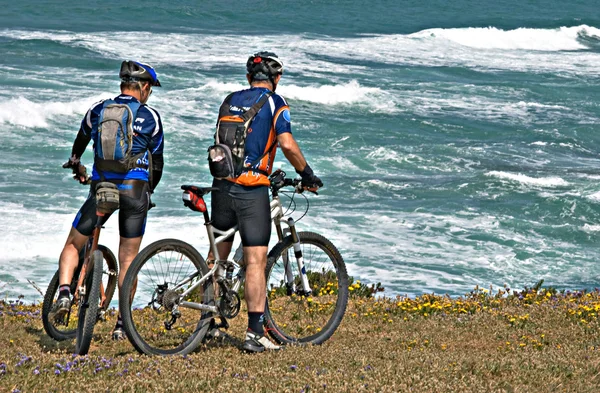 stock image Two cyclists on sea beach