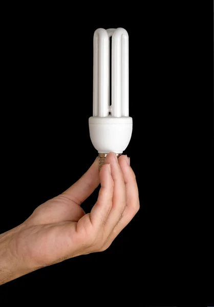 Mano sosteniendo una lámpara de ahorro de energía — Foto de Stock
