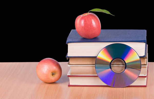 Apples, dvd, and books as symbols of transition fron old to ne — Stock Photo, Image