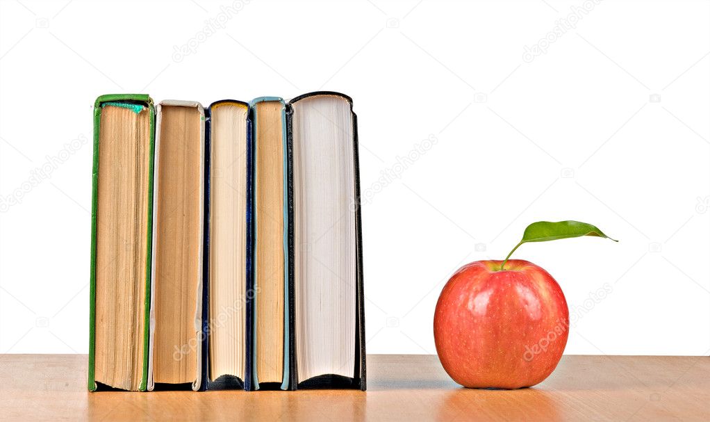 Red apple and books on desk
