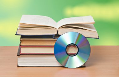 Open book and DVD disk as symbols of old and new methods of inf clipart