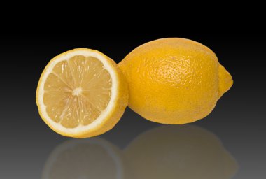 Lemon and section of lemon isolated on black background clipart