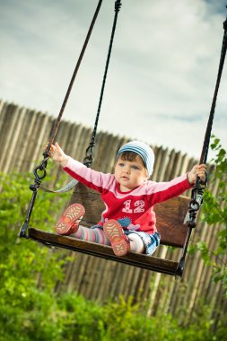 Child on the swings clipart