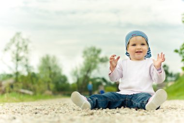 Child plays on the road clipart