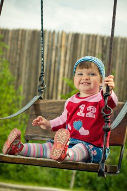 Beautiful girl on the swings clipart