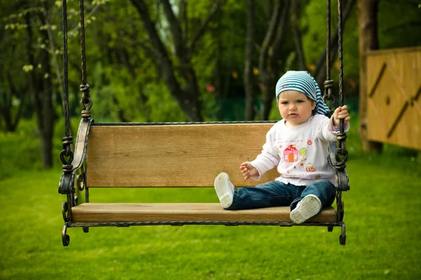 Beautiful child on the swings — Stock Photo, Image