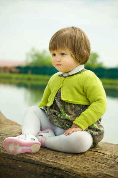 Girl on a wooden bench — Stock Photo, Image
