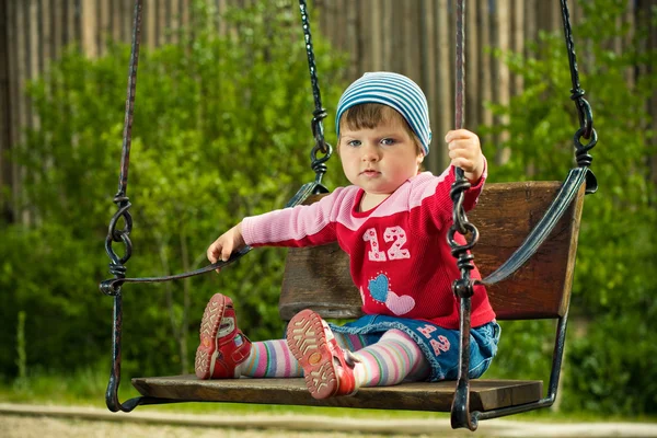 Beautiful girl on the swings — Stock Photo, Image