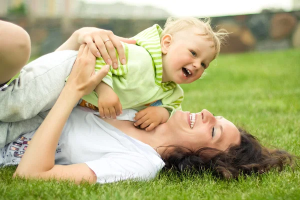 Mother with son on the grass — Stock Photo, Image