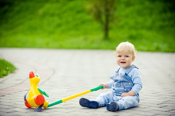 Хлопчик грає з качкою в парку — стокове фото