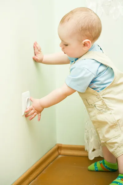 Child pulls to the socket — Stock Photo, Image