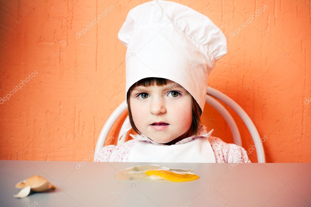 Young cook with broken egg
