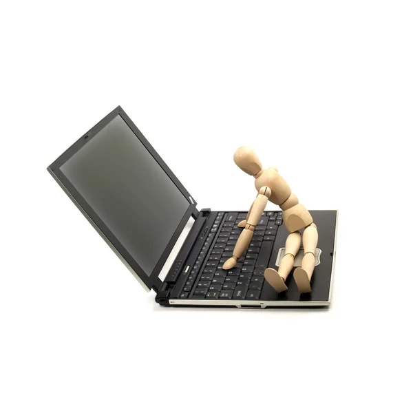 stock image Wood mannequin and laptop