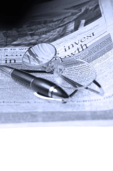 Ручка, очки и газета — стоковое фото