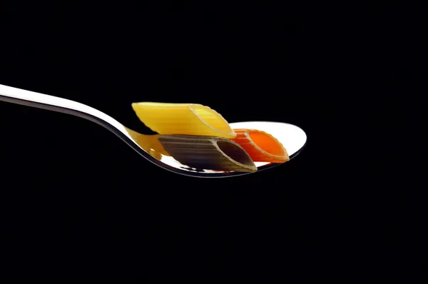 Italian penne pasta on a spoon — Stock Photo, Image