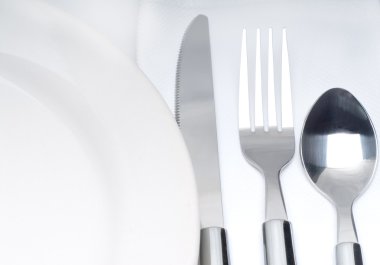 Cutlery set on a table clipart