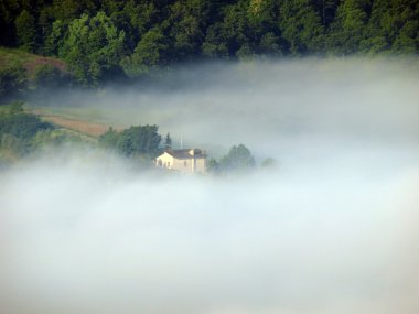 Fabulous landscape of the foggy morning in Tuscany. clipart