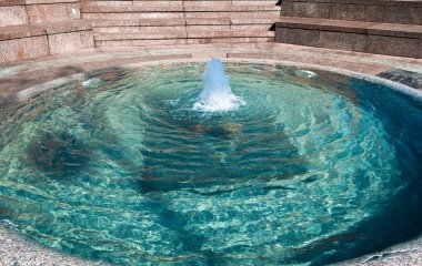 Clear water source in stone pool. clipart