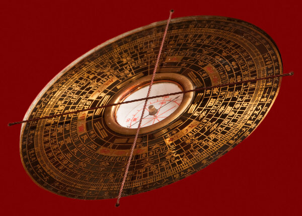 Feng shui compass Luopan on red background