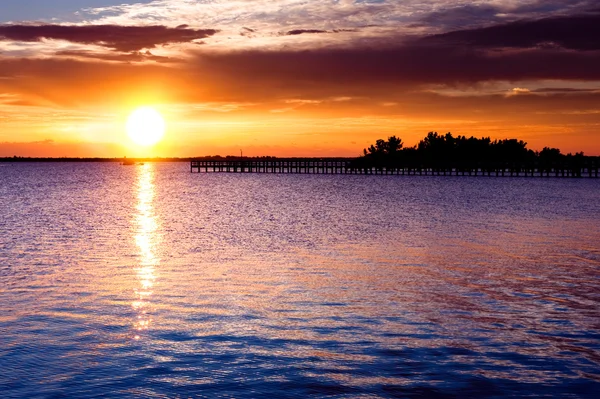 stock image Dramatic sunrise over river pier.