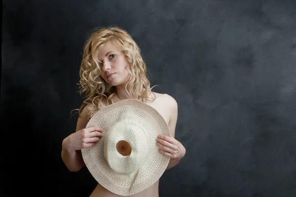 Young sexy blonde in the studio. Straw hat. — Stock Photo, Image