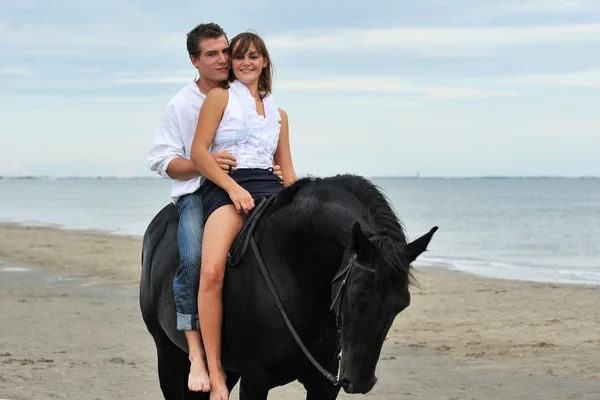 Paar und Pferd am Strand — Stockfoto