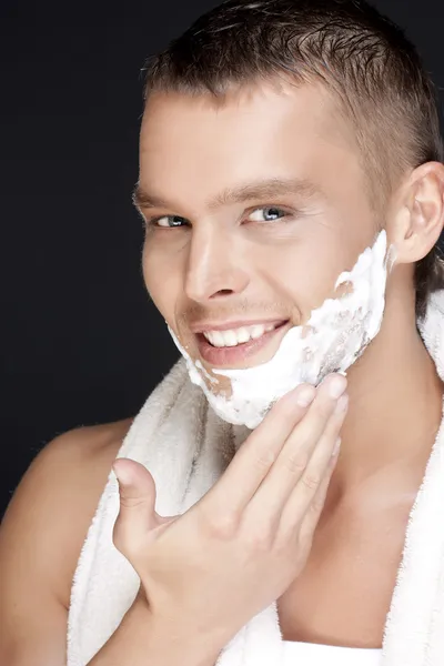 Handsome man shaves — Stock Photo, Image
